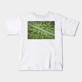 Empty road going diagonally through the forest top down aerial view Kids T-Shirt